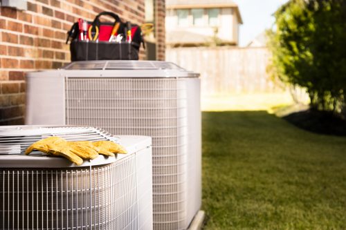 Service Industry: Work tools on air conditioners. Outside residential home. Friendswood AC and Heating